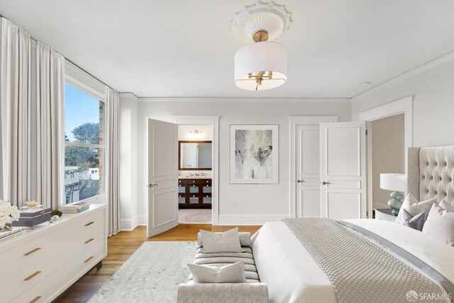 bedroom featuring light wood-type flooring and crown molding