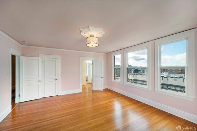 unfurnished bedroom with light wood-type flooring