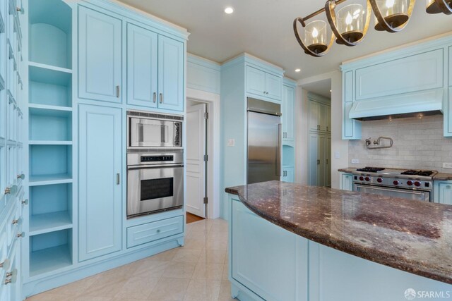 kitchen with custom exhaust hood, decorative light fixtures, backsplash, built in appliances, and an inviting chandelier