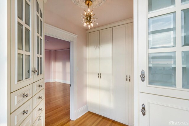 interior space with an inviting chandelier and light wood-type flooring