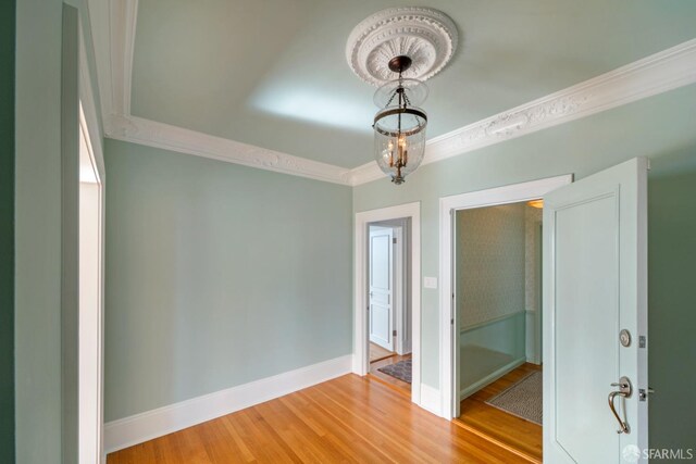 unfurnished room with wood-type flooring and crown molding