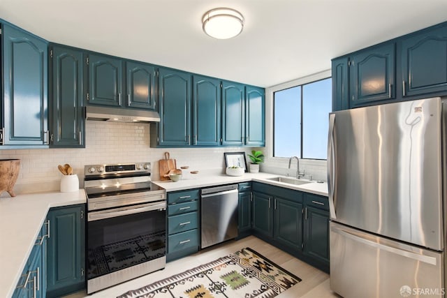 1278 La Playa St, San Francisco, CA 94122 - kitchen featuring appliances with stainless steel finishes, a sink, under cabinet range hood, backsplash, and light countertops