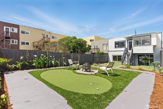 1278 La Playa St, San Francisco, CA 94122 - view of community featuring a putting green, an outdoor fire pit, fence, and stairway