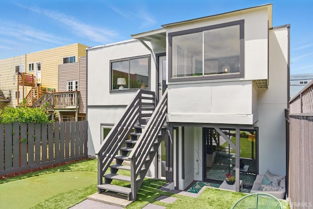 1278 La Playa St, San Francisco, CA 94122 - back of property featuring a putting area, stairway, fence, and stucco siding