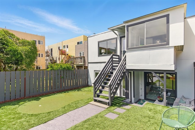 1278 La Playa St, San Francisco, CA 94122 - rear view of house featuring a putting green, a fenced backyard, and stucco siding