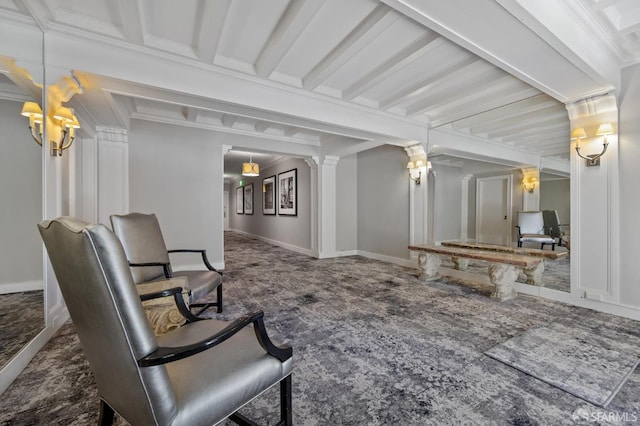 living area with carpet floors, decorative columns, ornamental molding, and baseboards