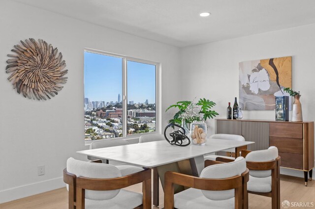 226 Rutledge St, San Francisco, CA 94110 - dining room with light wood-style flooring, recessed lighting, a skyline view, and baseboards