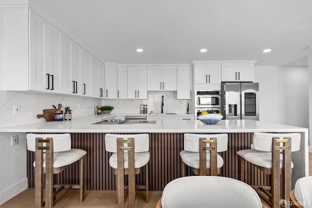 226 Rutledge St, San Francisco, CA 94110 - kitchen featuring appliances with stainless steel finishes, white cabinetry, light countertops, a sink, and recessed lighting
