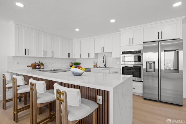 226 Rutledge St, San Francisco, CA 94110 - kitchen with stainless steel appliances, a sink, backsplash, white cabinets, and recessed lighting