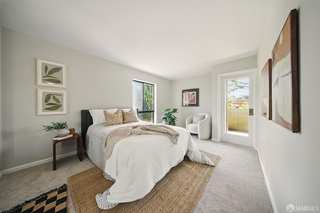 16006 E 14th St Unit 101, San Leandro, CA 94578 - bedroom featuring light colored carpet, baseboards, and access to exterior