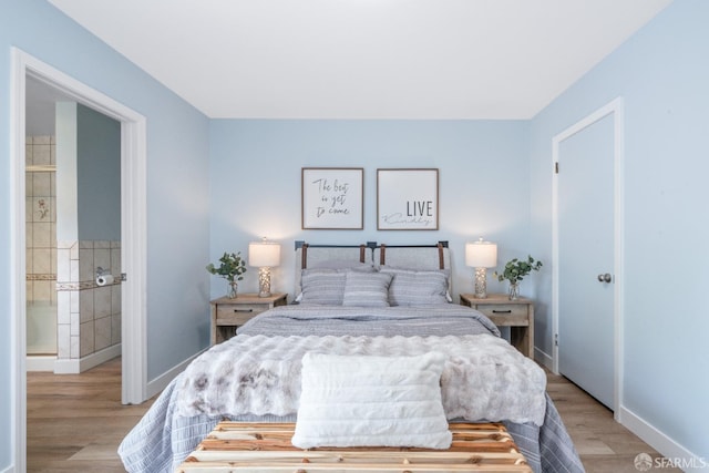 bedroom with baseboards and light wood-style floors