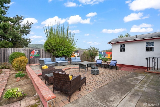 view of patio featuring outdoor lounge area and fence