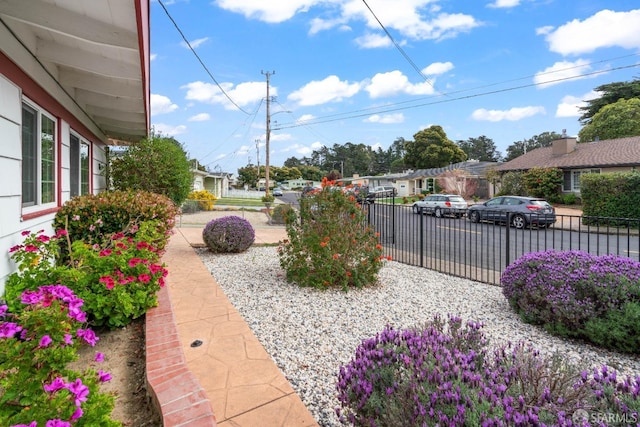 view of yard featuring a residential view and fence