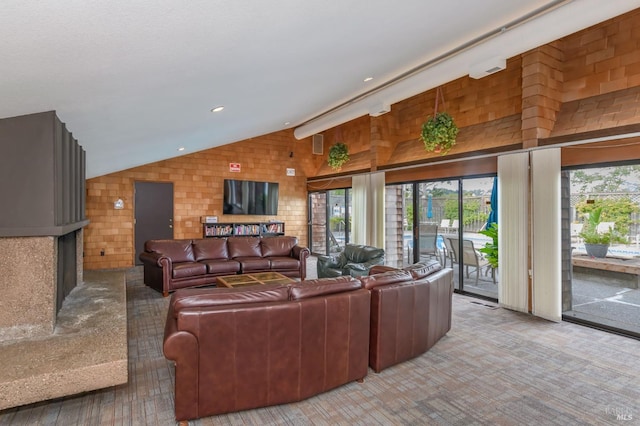 living room featuring recessed lighting, plenty of natural light, and vaulted ceiling