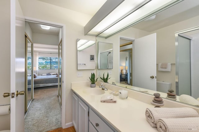 bathroom with vanity, ensuite bath, and toilet