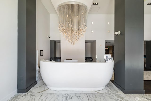 reception area with a high ceiling and a chandelier