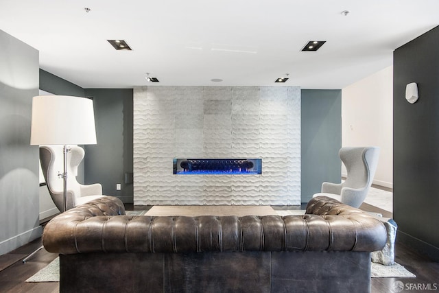 living room with a fireplace, wood finished floors, and baseboards