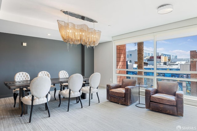 dining room with carpet floors and a chandelier