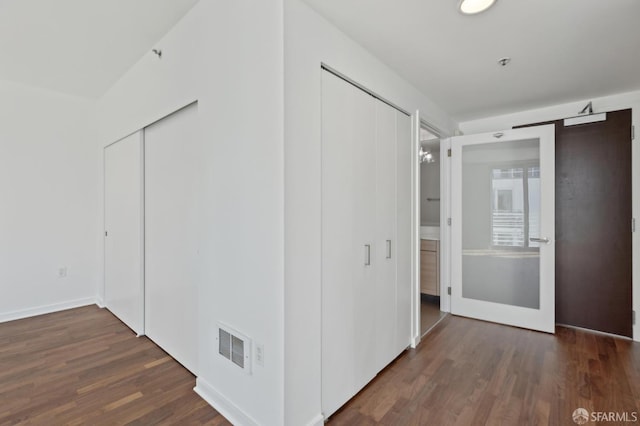 interior space featuring wood finished floors and baseboards