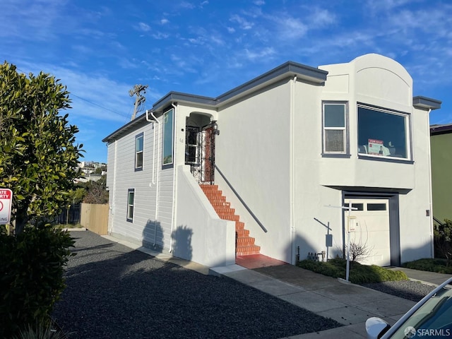 view of home's exterior featuring stairway, fence, and stucco siding