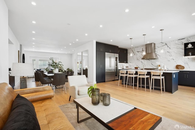 living area featuring recessed lighting and light wood finished floors