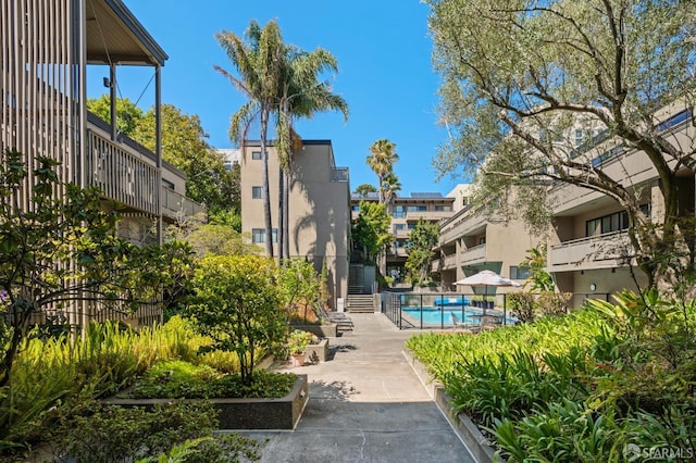 surrounding community featuring a pool and a patio