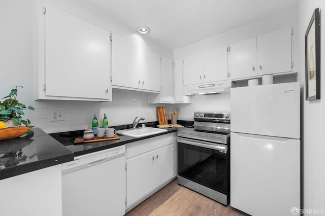 kitchen with sink, white cabinetry, tasteful backsplash, white appliances, and light hardwood / wood-style floors