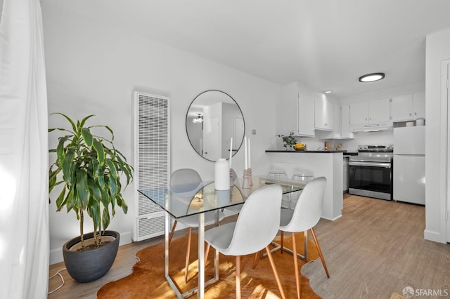 dining room with light wood-type flooring