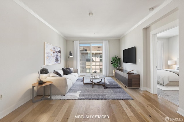 living room with light hardwood / wood-style floors and ornamental molding