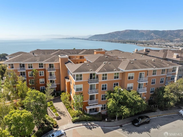 view of building exterior featuring a water and mountain view