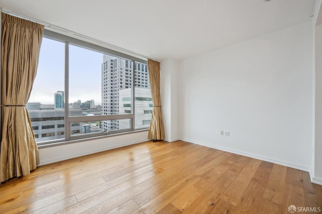 unfurnished room featuring light hardwood / wood-style floors