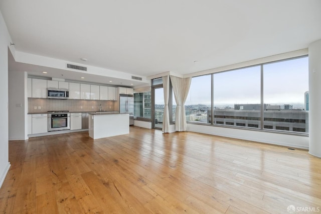 unfurnished living room featuring light hardwood / wood-style flooring