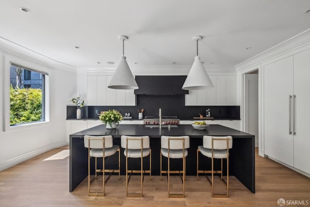 kitchen with dark countertops, modern cabinets, white cabinets, backsplash, and ornamental molding