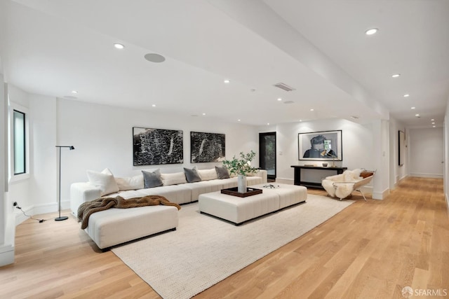 living room featuring recessed lighting, light wood-type flooring, and baseboards