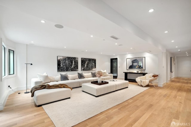 living area with baseboards, light wood-style flooring, and recessed lighting