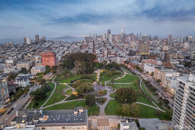 aerial view of property and surrounding area with nearby urban area and a recreational park