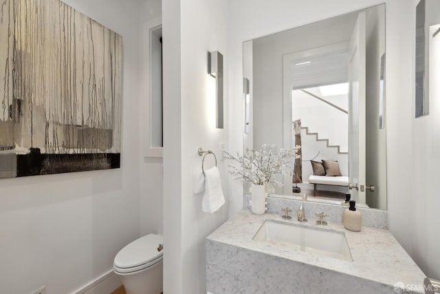 bathroom featuring toilet and vanity