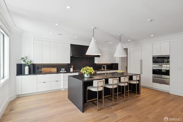 kitchen featuring stainless steel oven, modern cabinets, dark countertops, a warming drawer, and black microwave