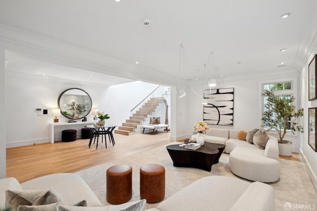living area featuring stairs, light wood finished floors, crown molding, baseboards, and recessed lighting
