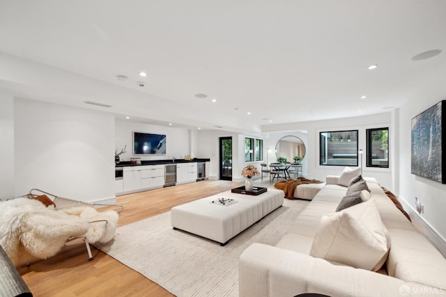 living room with light wood-style floors, healthy amount of natural light, and recessed lighting