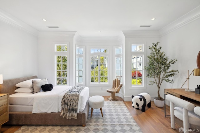 bedroom featuring light wood-type flooring, crown molding, and recessed lighting