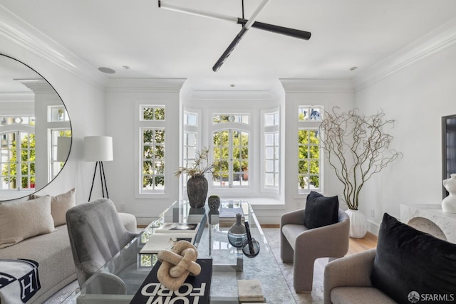 living room featuring ornamental molding, arched walkways, wood finished floors, and baseboards