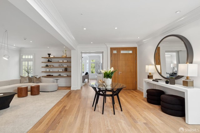 entryway with light wood finished floors, recessed lighting, plenty of natural light, crown molding, and baseboards