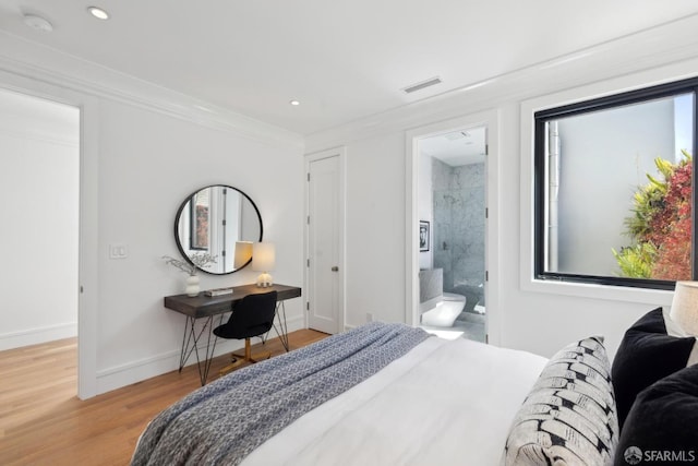bedroom featuring light wood-type flooring, recessed lighting, baseboards, crown molding, and ensuite bathroom