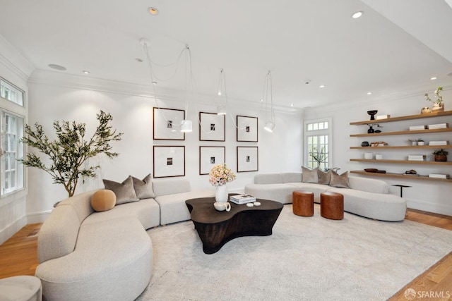 living area with crown molding, wood finished floors, and recessed lighting