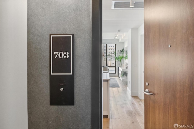 hall with light hardwood / wood-style floors