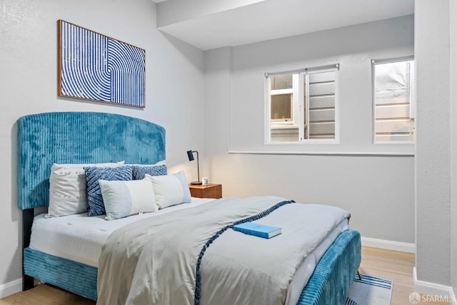 bedroom with light wood-style flooring and baseboards