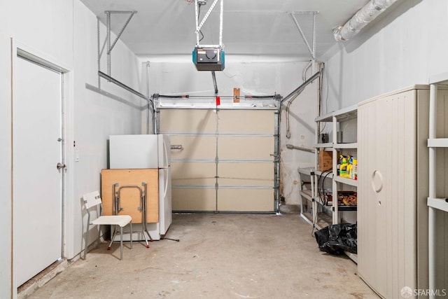 garage with a garage door opener and freestanding refrigerator