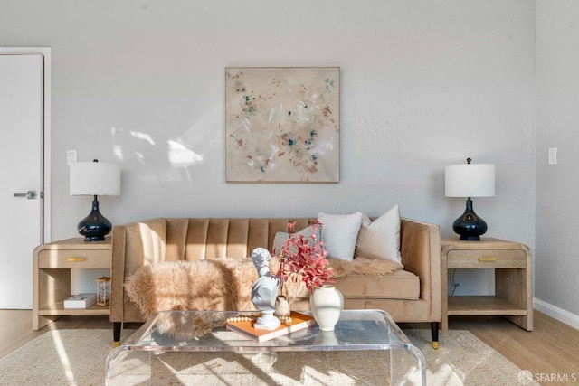 living area featuring light wood-type flooring and baseboards