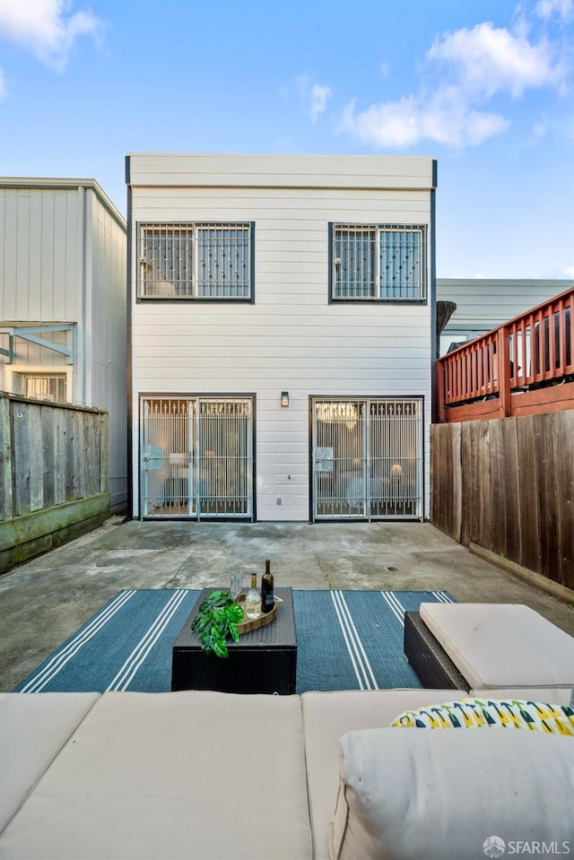 back of house featuring a patio area, fence, and outdoor lounge area